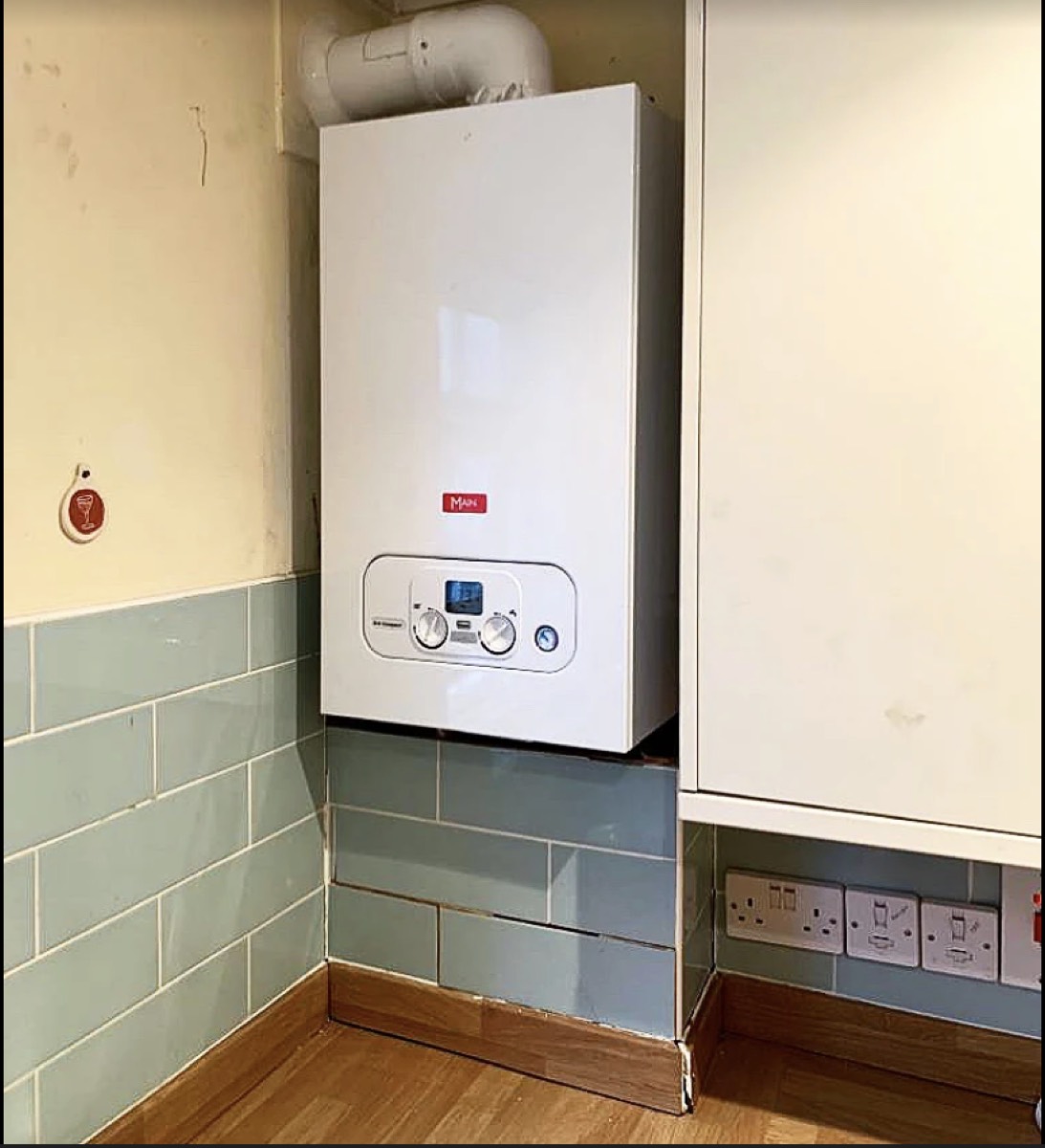 New Main combi boiler installed above tiled wall in an East London kitchen